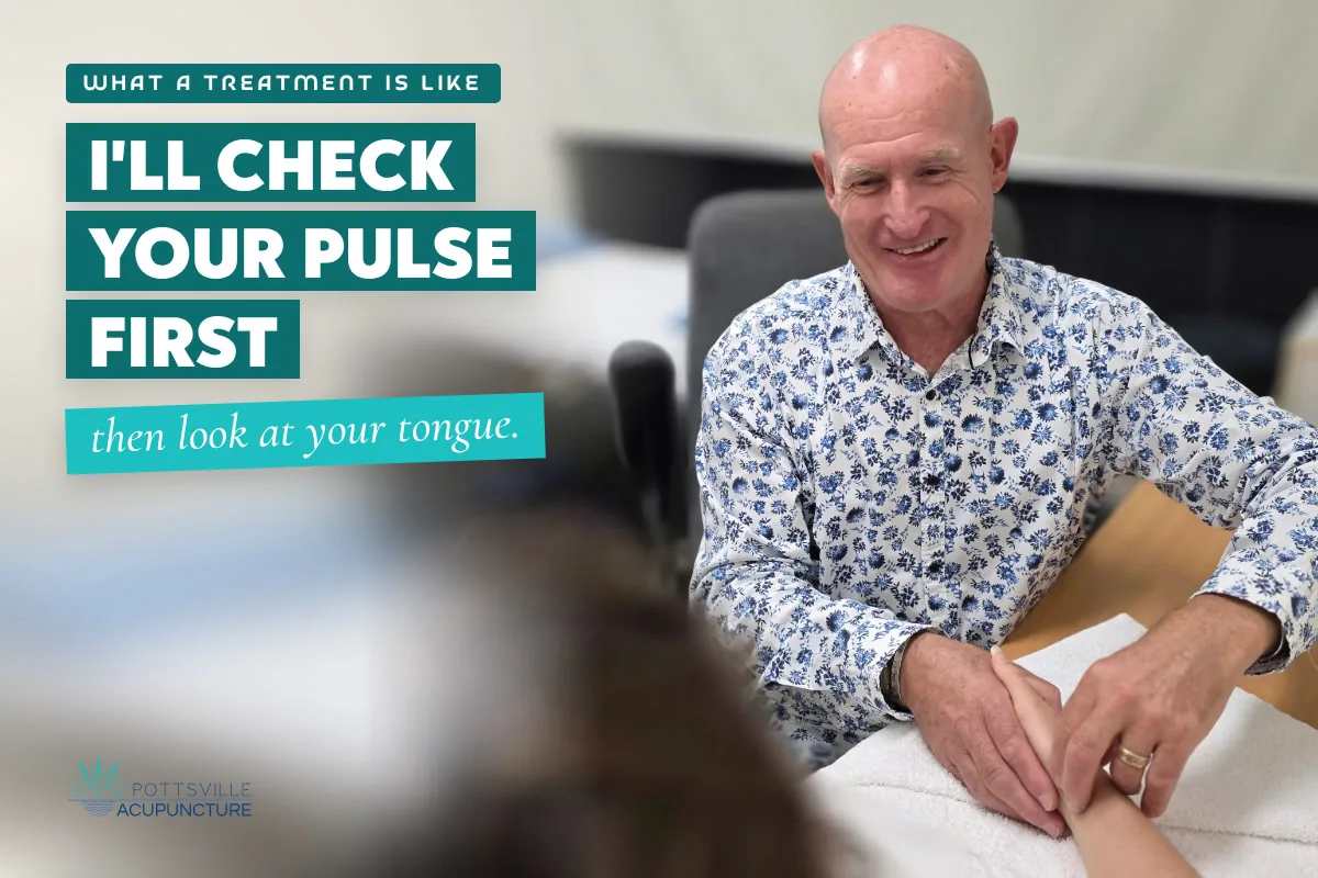 Dr Mal reading the pulse at the wrist at Pottsville Acupuncture, Hastings Point.